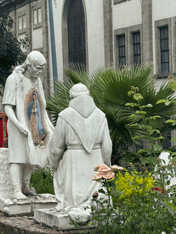 Stone sculpture of Juan Diego showing the image of Our Lady of Guadalupe on his tilma