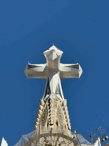 Cross at the Sagrada Família set against a blue Barcelona sky